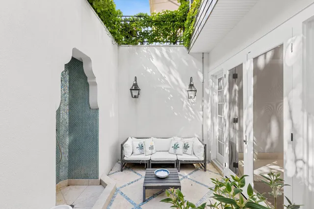 a wooden bench sitting in front of a window