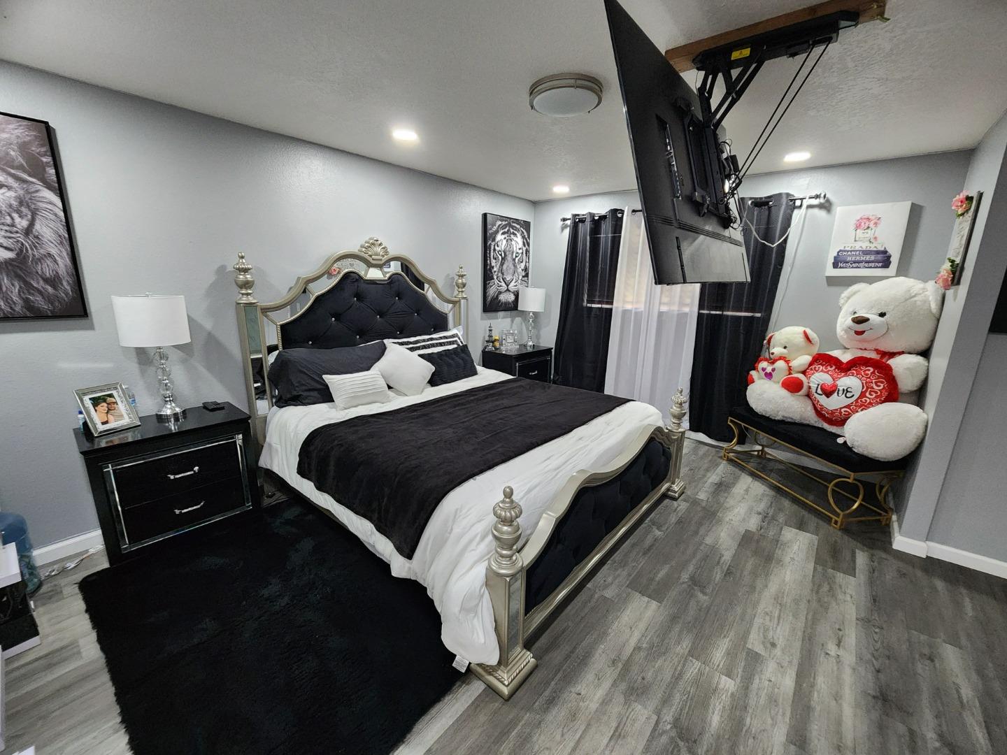 601 Weyer Road Modesto, CA 95357 - Photo 15 of 27 a spacious bedroom with a bed and a chandelier