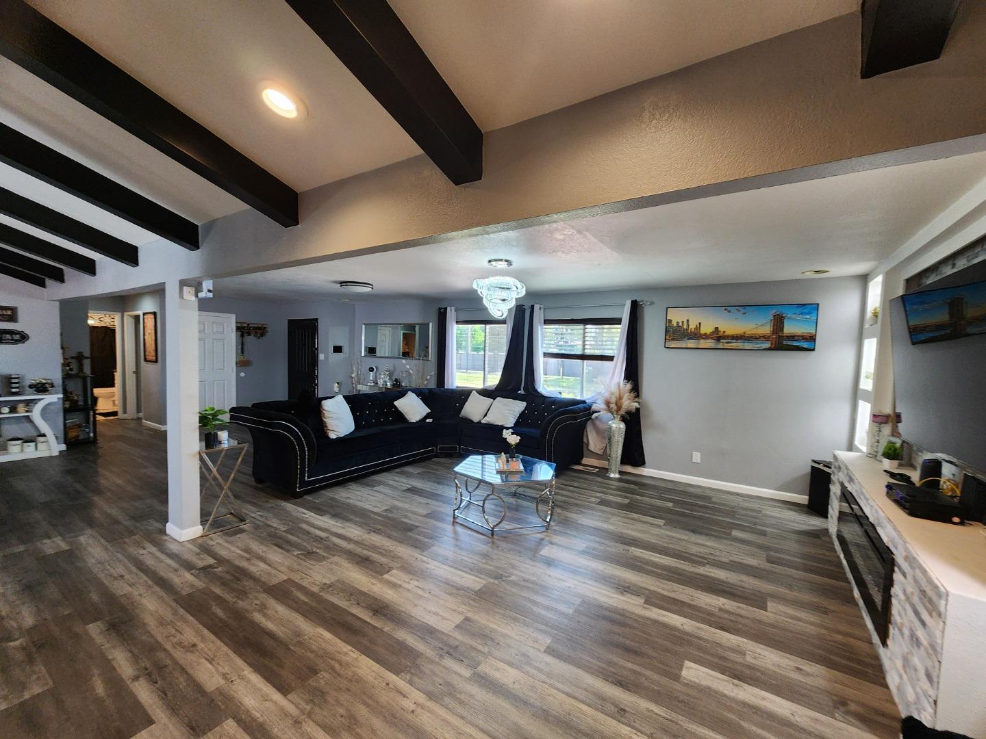 601 Weyer Road Modesto, CA 95357 - Photo 4 of 27 a living room with furniture a flat screen tv and a table