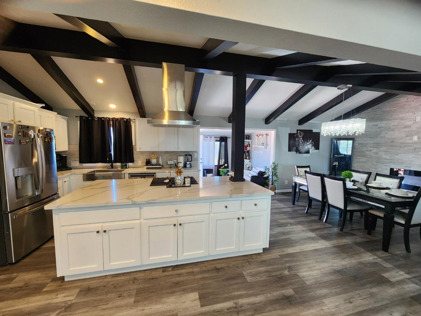 601 Weyer Road Modesto, CA 95357 - Photo 9 of 27 a large white kitchen with lots of counter space and a sink