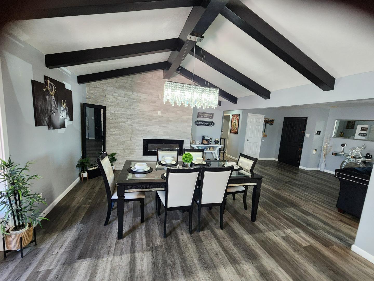 601 Weyer Road Modesto, CA 95357 - Photo 10 of 27 a dining room with furniture wooden floor and a rug