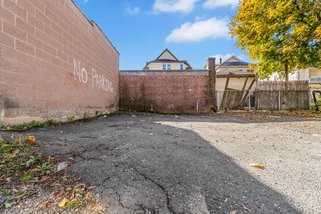a view of a large house with a yard and large trees