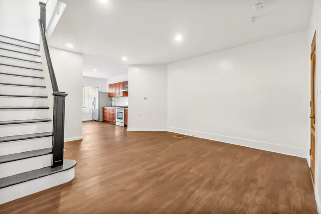 a view of livingroom with stairs and wooden floor