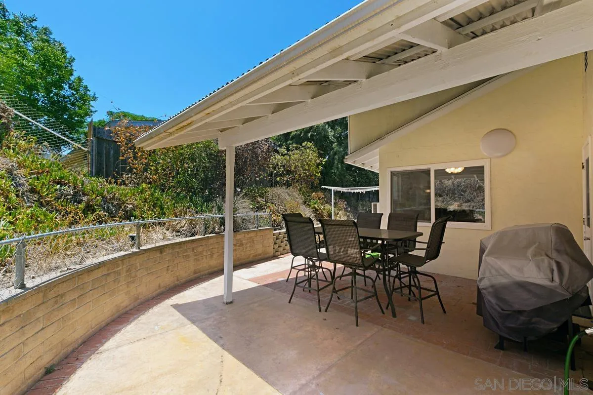 11615 Westridge Place Lakeside, CA 92040 - Photo 21 of 29 a view of a patio with table and chairs and floor to ceiling window with potted plants