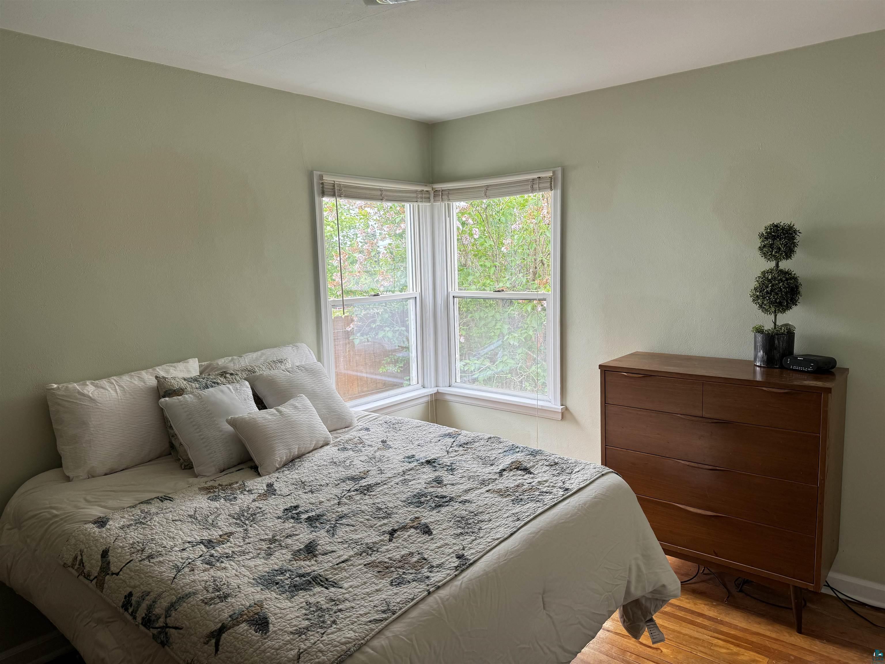 4416 Oneida Street Duluth, MN 55804 - Photo 6 of 12 Bedroom with multiple windows and hardwood / wood-style floors