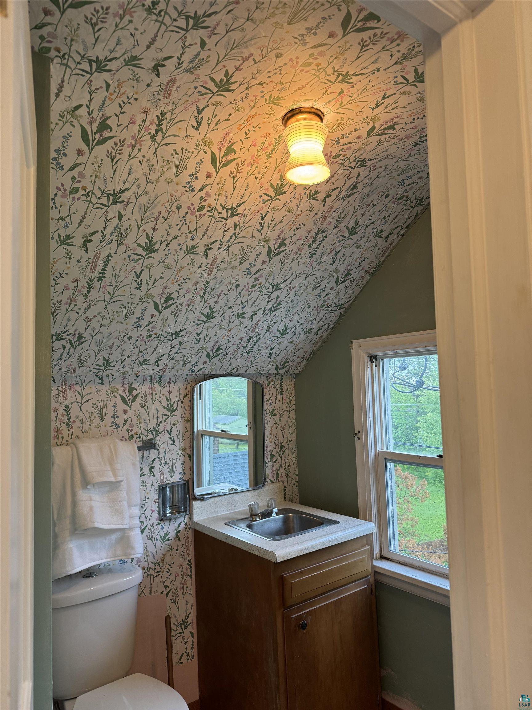 4416 Oneida Street Duluth, MN 55804 - Photo 8 of 12 Bathroom featuring lofted ceiling, toilet, and vanity