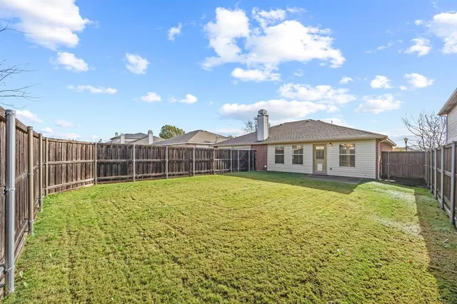 a front view of house with yard space and outdoor seating