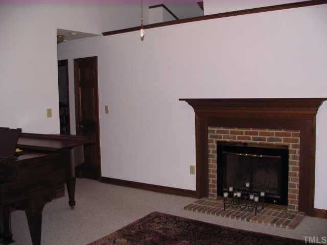 917 Fairlong Road Wake Forest, NC 27587 - Photo 4 of 12 LR with vaulted ceilings, masonry fireplace and access to master bedroom, kitchen and hallway to bedrooms 2 & 3 Other