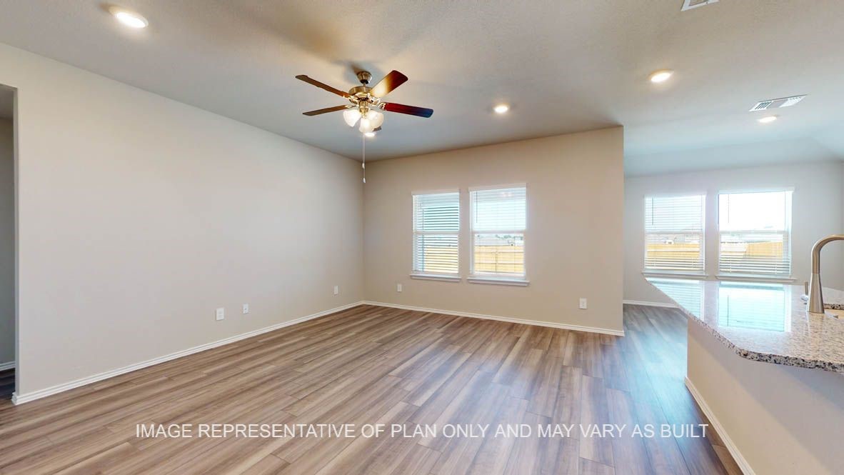 2912 Taddy Road Lorena, TX 76655 - Photo 9 of 22 an empty room with wooden floor fan and windows