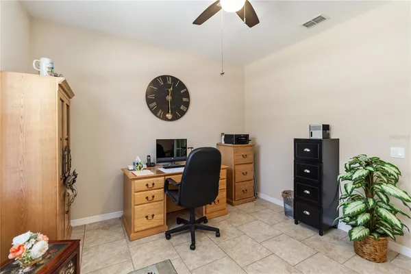 a view of a workspace with furniture and a fan