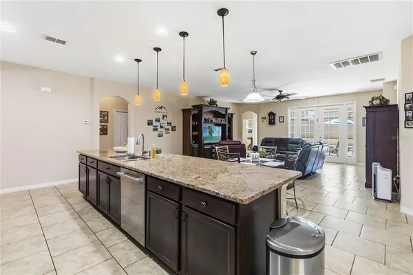 a kitchen with stainless steel appliances granite countertop a stove a sink and a refrigerator