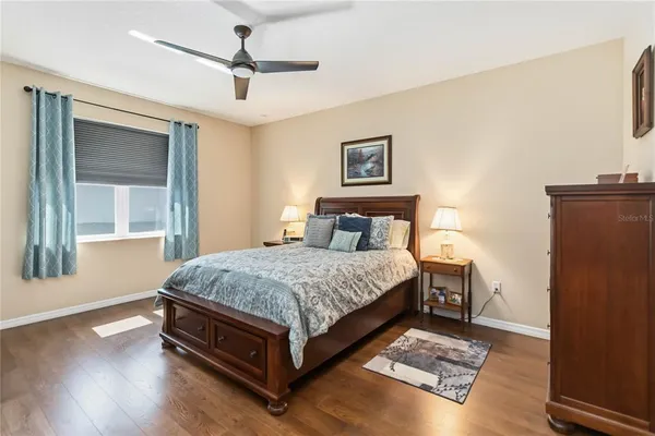 a bed sitting in a bedroom next to a window