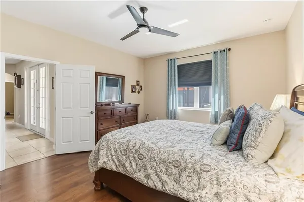 a bedroom with a bed and a large mirror