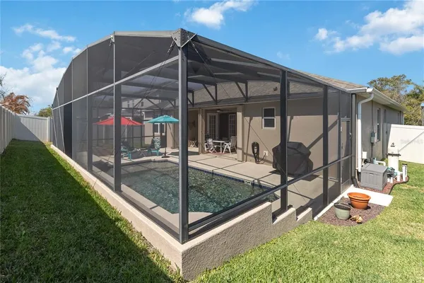 a view of a backyard with sitting area and garden