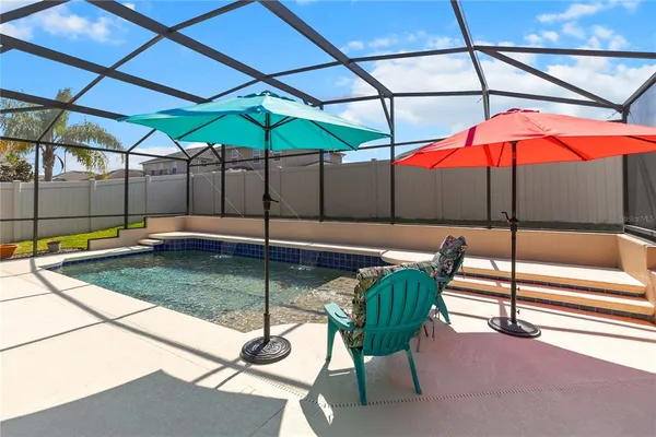 a view of a backyard with a patio and fire pit
