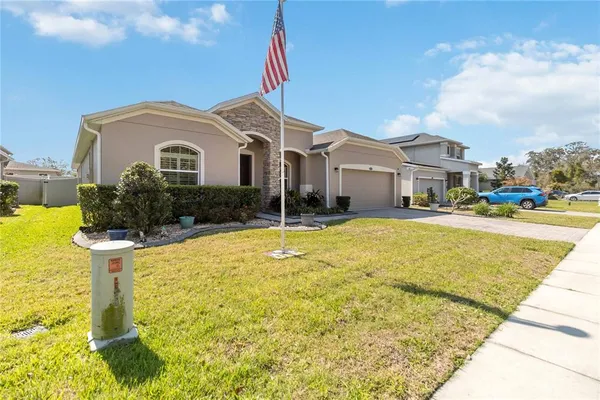 a front view of house with yard and swimming pool