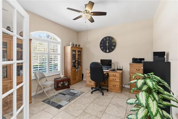a view of a workspace with furniture and a window