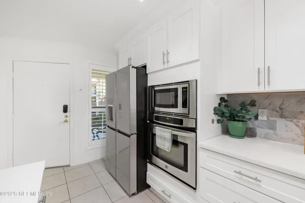 a kitchen with stainless steel appliances a refrigerator and cabinets