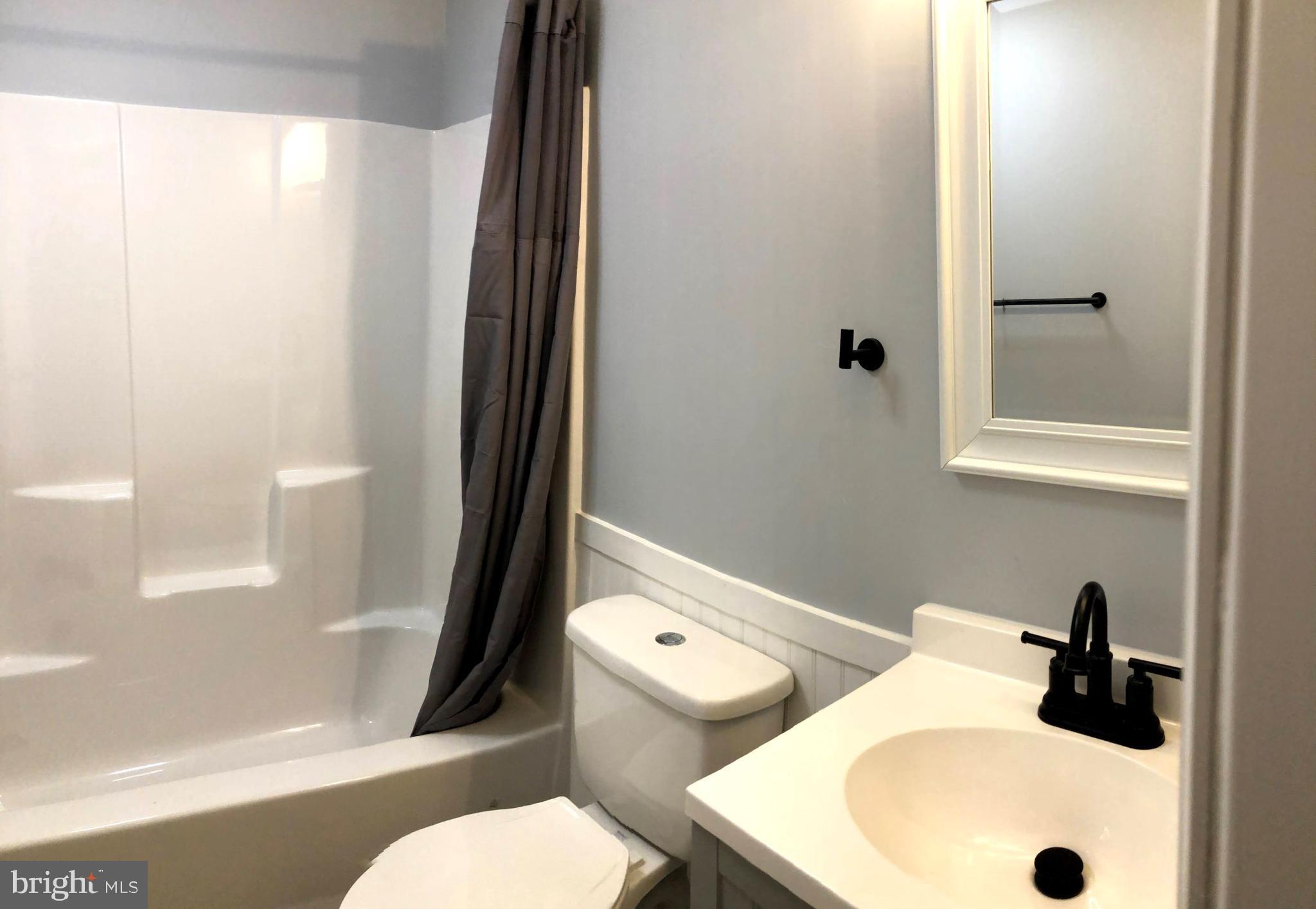 102 Haddon Road Browns Mills, NJ 08015 - Photo 8 of 12 a bathroom with a sink and a mirror