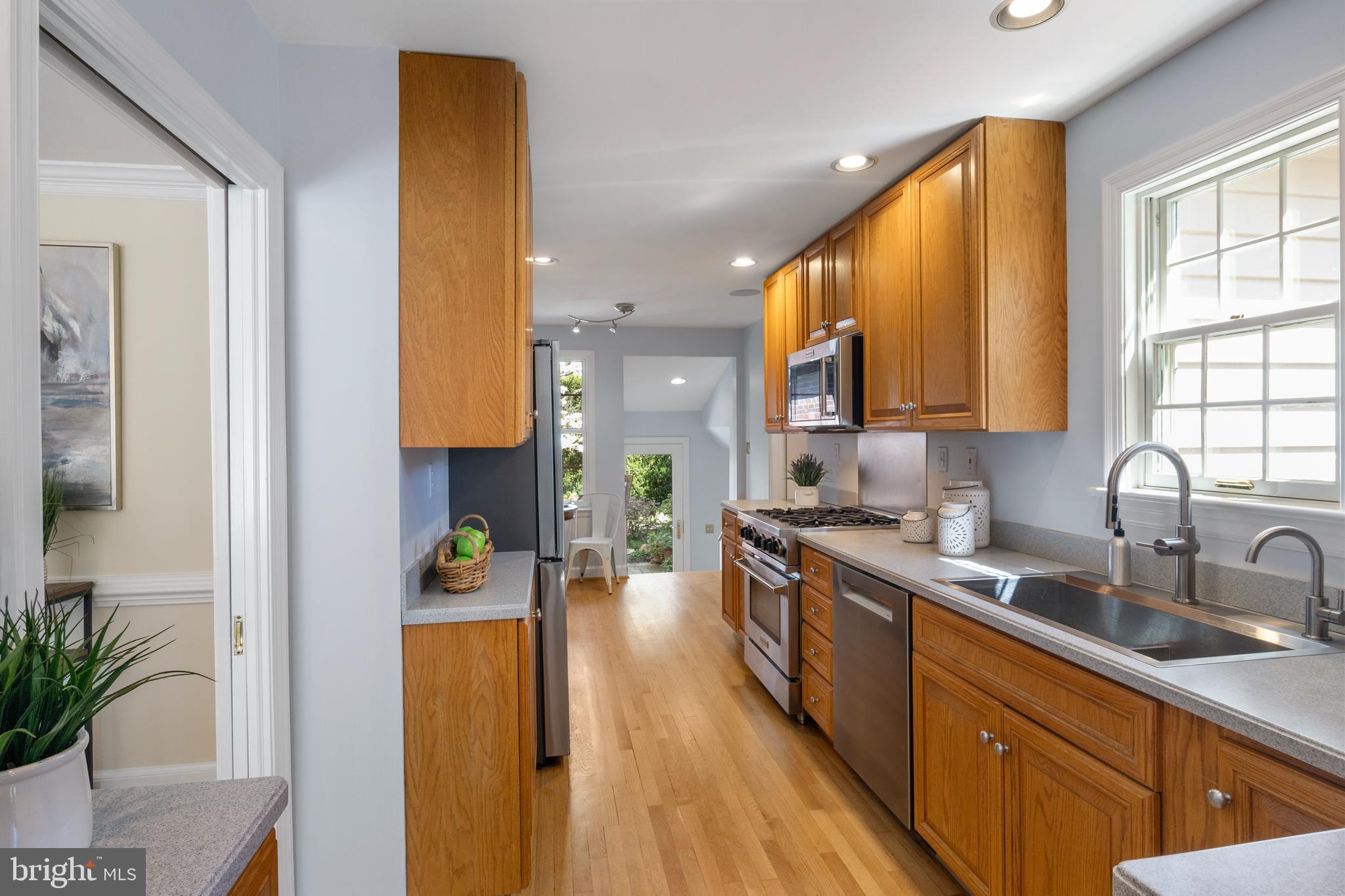 5624 Madison Street Bethesda, MD 20817 - Photo 12 of 28 a kitchen with a sink a counter top space and cabinets