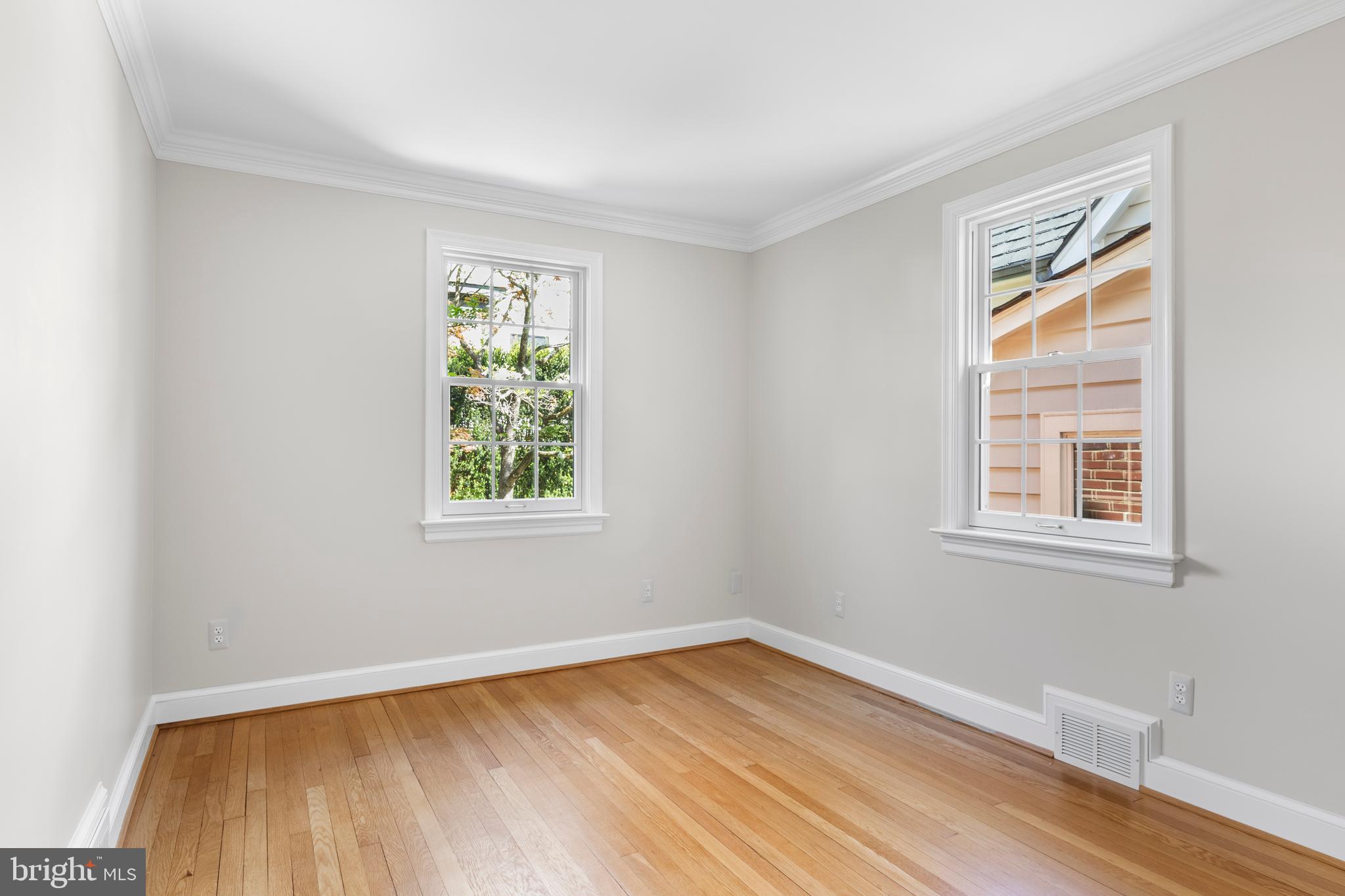 5624 Madison Street Bethesda, MD 20817 - Photo 19 of 28 a view of an empty room with wooden floor and a window