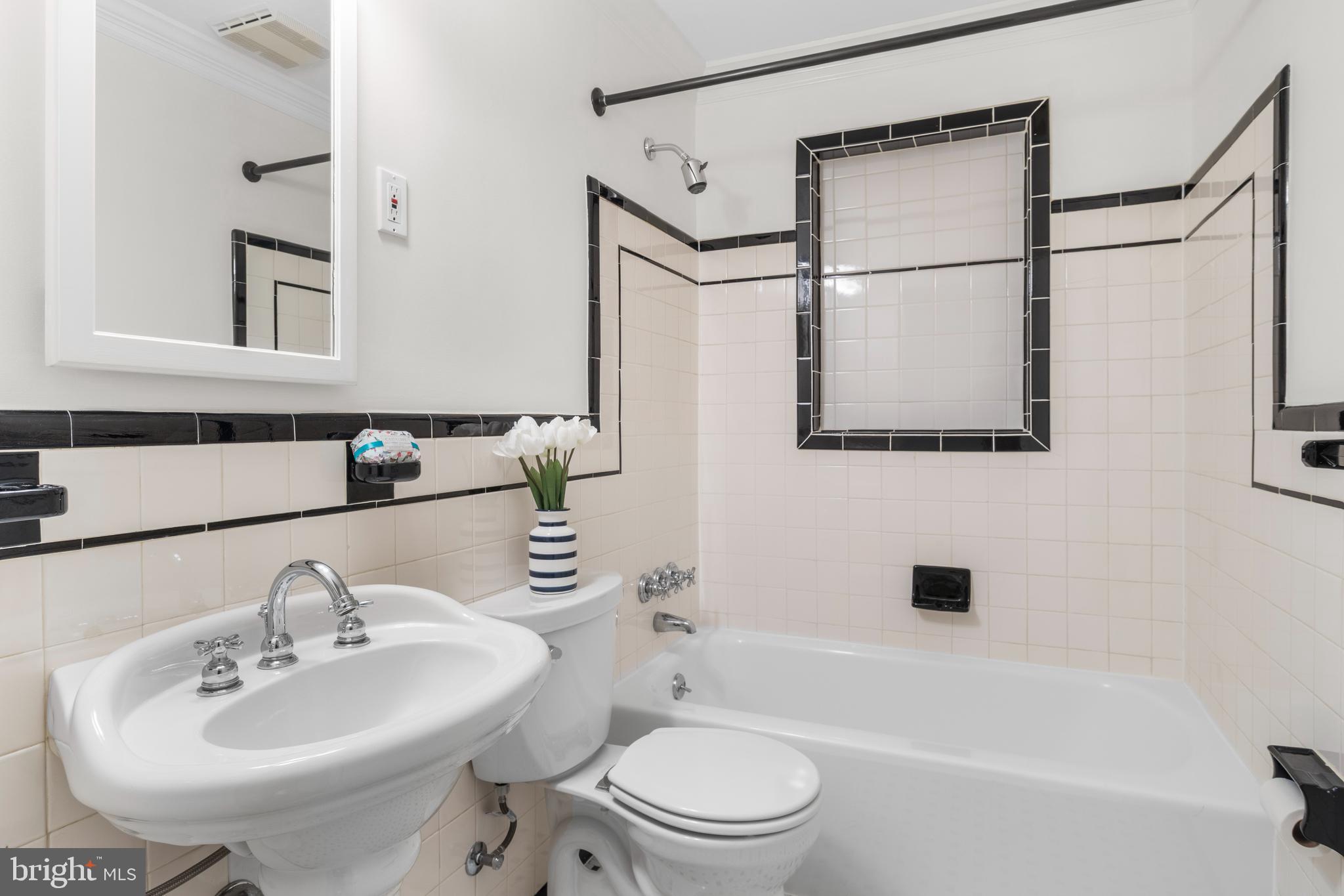 5624 Madison Street Bethesda, MD 20817 - Photo 21 of 28 a bathroom with a sink toilet and shower