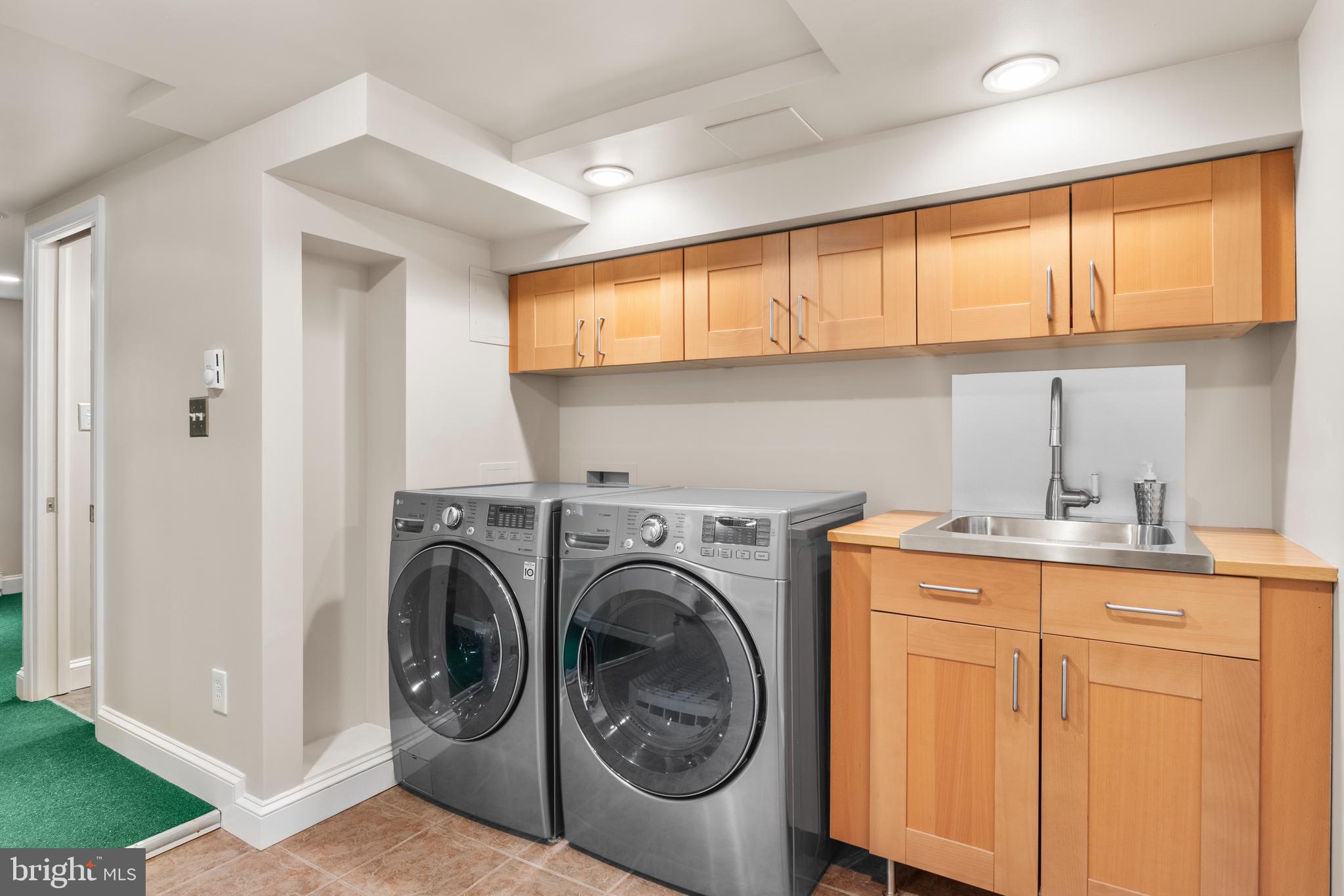 5624 Madison Street Bethesda, MD 20817 - Photo 22 of 28 a utility room with sink dryer and washer