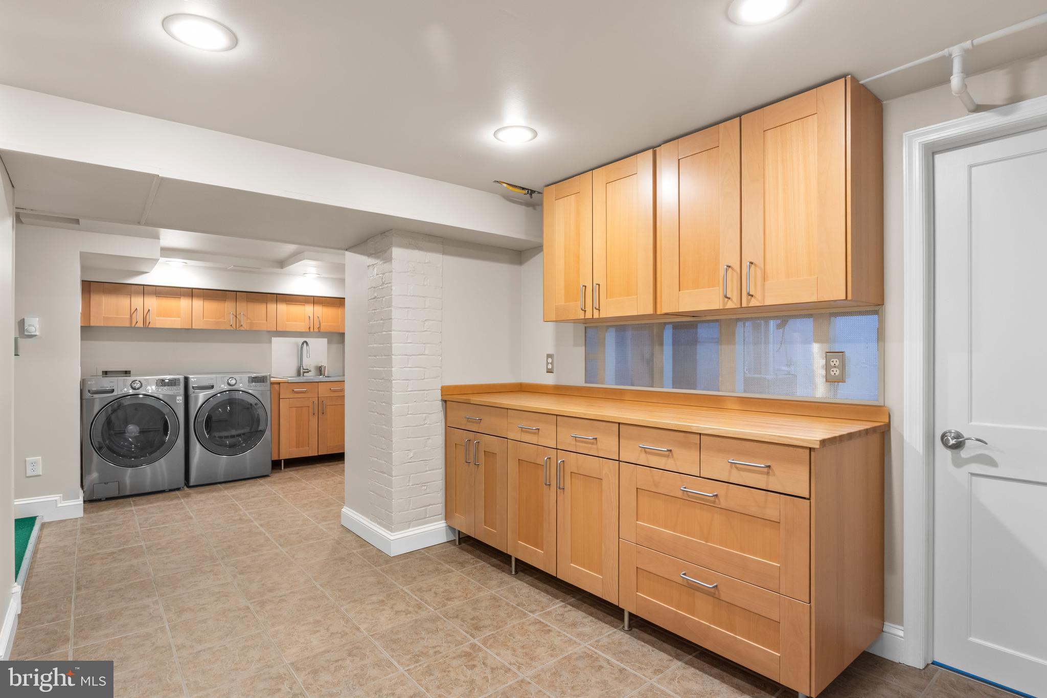 5624 Madison Street Bethesda, MD 20817 - Photo 23 of 28 a kitchen with stainless steel appliances granite countertop a sink and cabinets with wooden floor