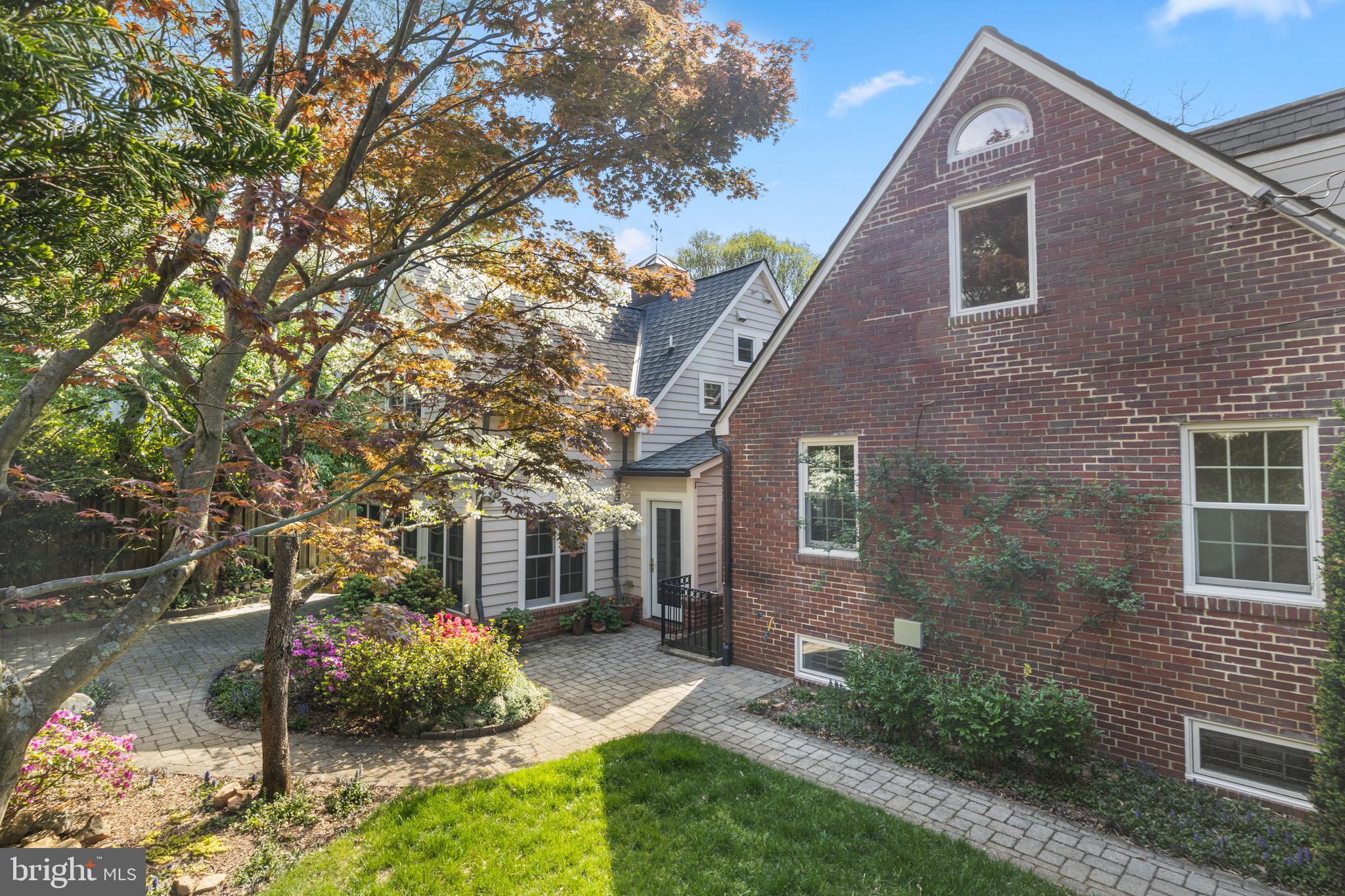 5624 Madison Street Bethesda, MD 20817 - Photo 4 of 28 a front view of a house with a yard and potted plants