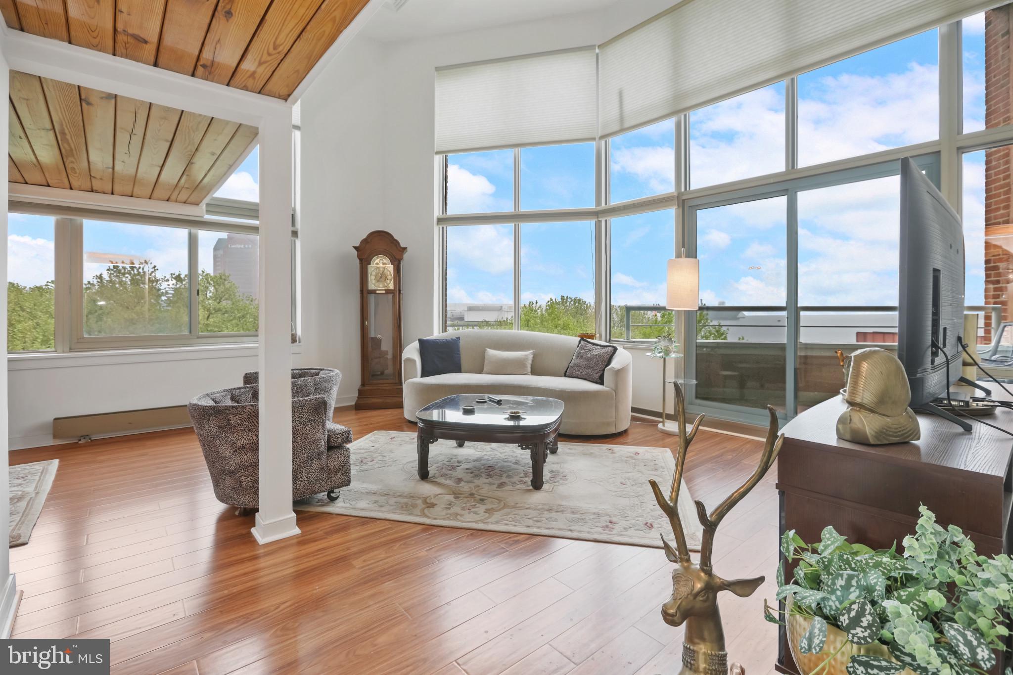 a living room with furniture and a floor to ceiling window