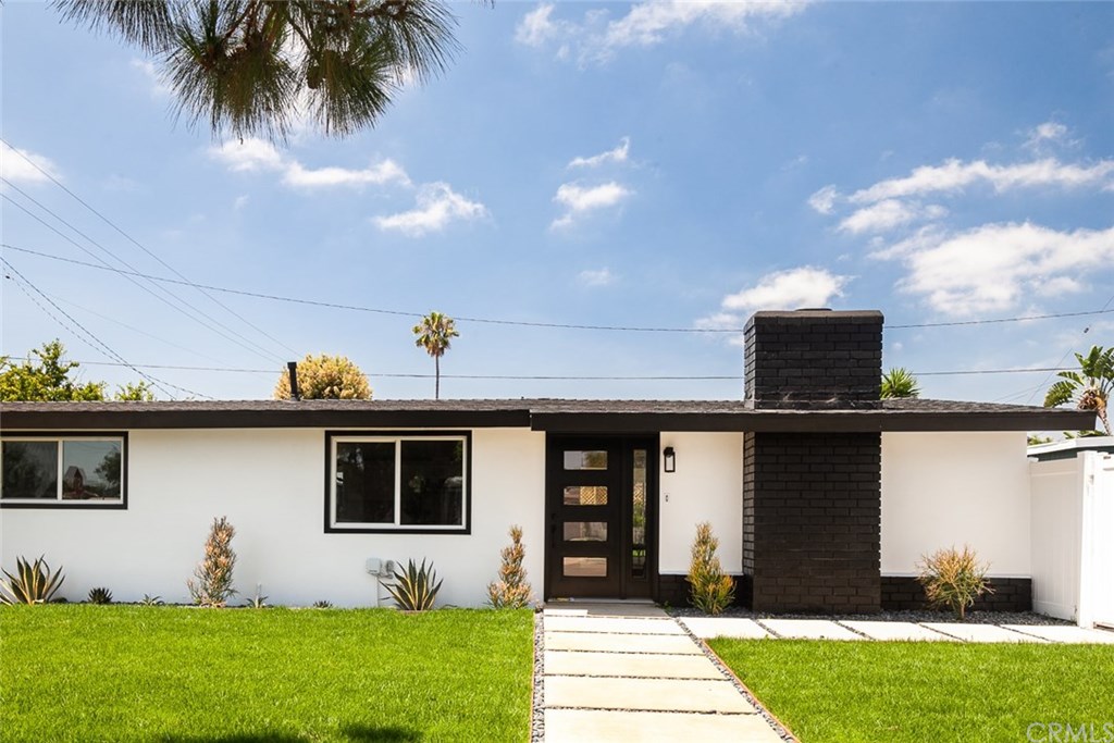 297 Rose Lane Costa Mesa, CA 92627 - Photo 13 of 17 a front view of a house with a yard and garage