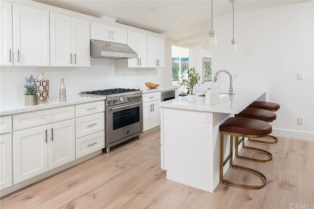 297 Rose Lane Costa Mesa, CA 92627 - Photo 4 of 17 a kitchen with a sink cabinets and appliances