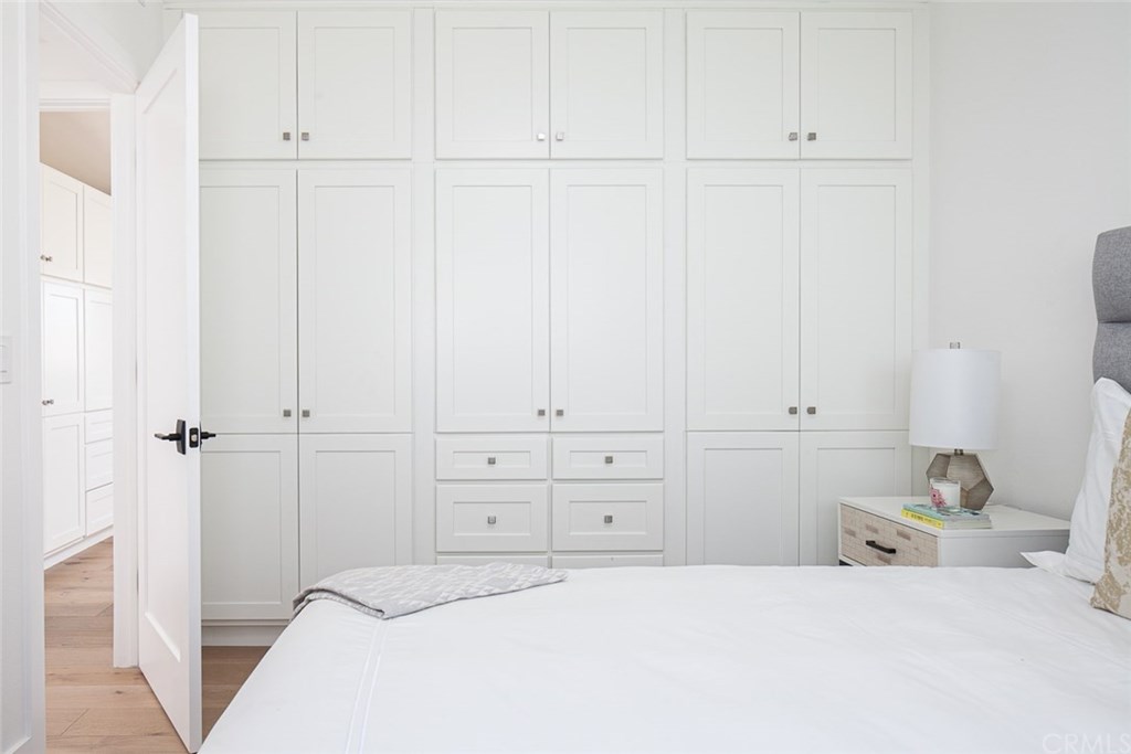 297 Rose Lane Costa Mesa, CA 92627 - Photo 6 of 17 a bedroom with a bed and a cabinets