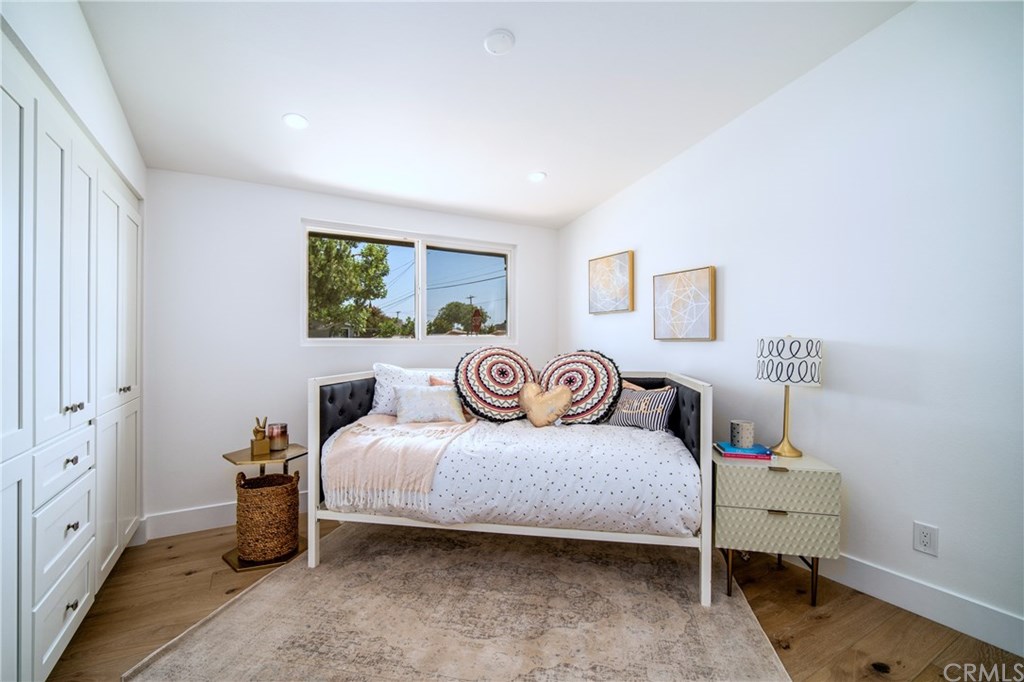 297 Rose Lane Costa Mesa, CA 92627 - Photo 8 of 17 a bedroom with a bed and wooden floor