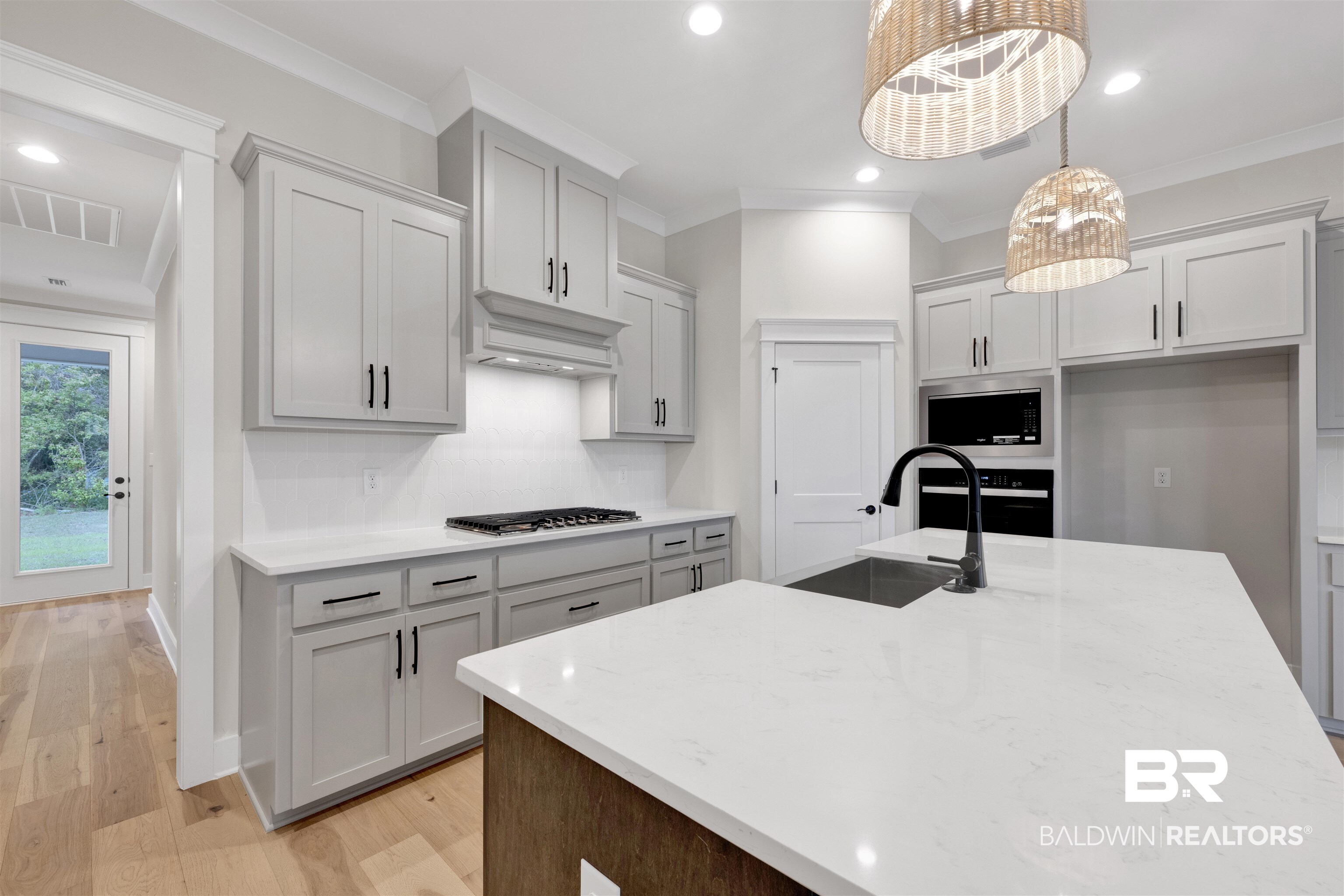 27382 Patch Pl Loop Daphne, AL 36526 - Photo 15 of 31 Kitchen with light stone countertops, light wood finished floors, ornamental molding, a kitchen island with sink, and stainless steel appliances