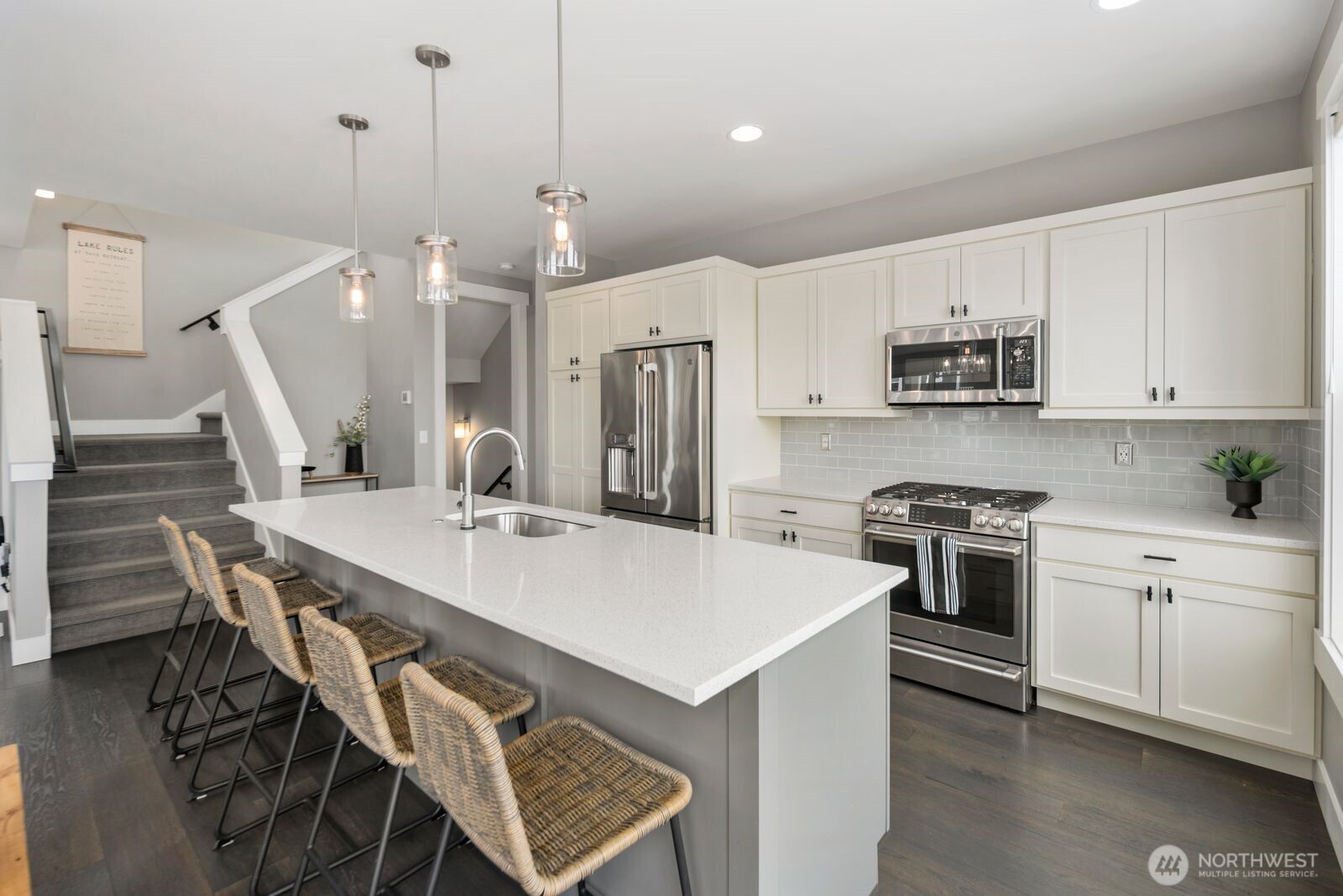 298 Bobcat Lane Chelan, WA 98816 - Photo 15 of 40 a kitchen with stainless steel appliances kitchen island a table chairs sink and cabinets