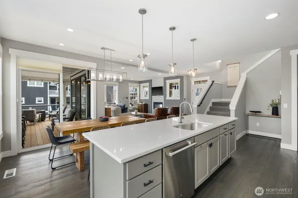 a kitchen with stainless steel appliances granite countertop a sink and stove