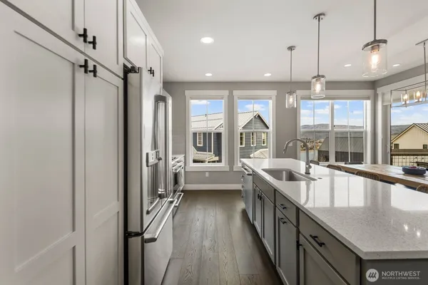 a large kitchen with a large window and stainless steel appliances