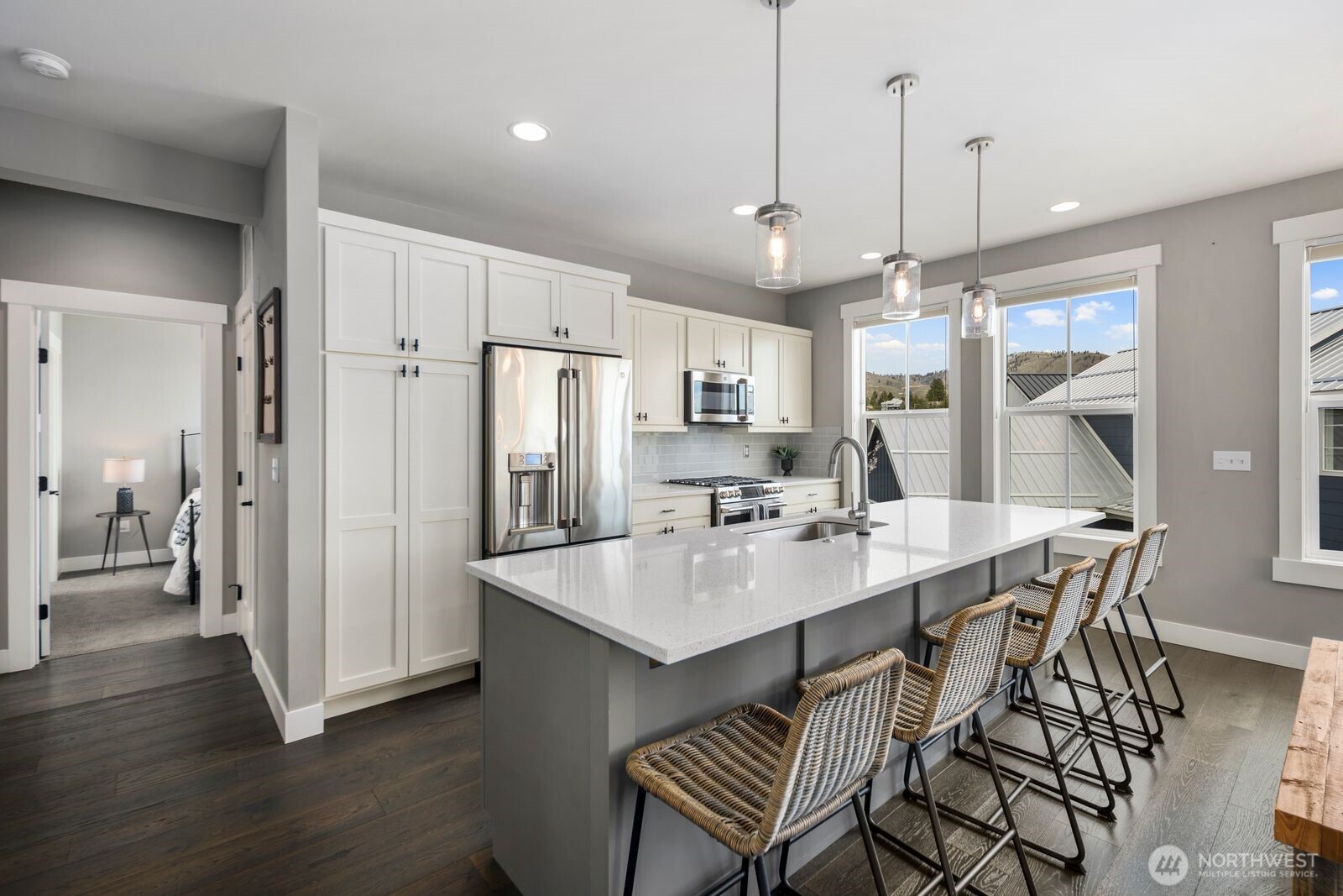 298 Bobcat Lane Chelan, WA 98816 - Photo 18 of 40 a kitchen with stainless steel appliances a dining table chairs and wooden floor