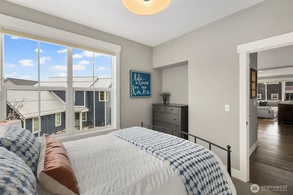 a bedroom with a bed and a view of living room
