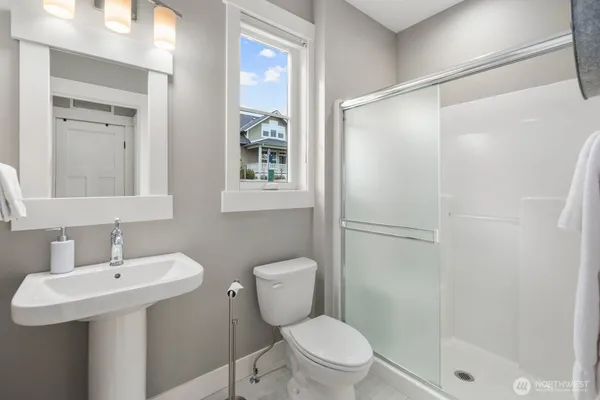 a bathroom with a sink toilet and shower