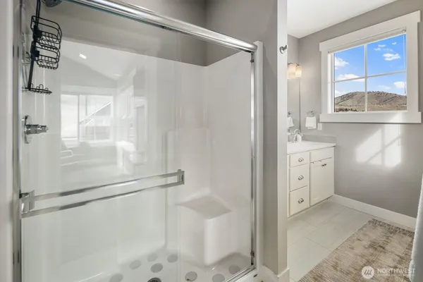 a bathroom with a shower and a sink