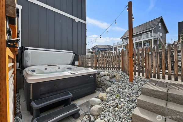 a view of barbecue area and wooden fence