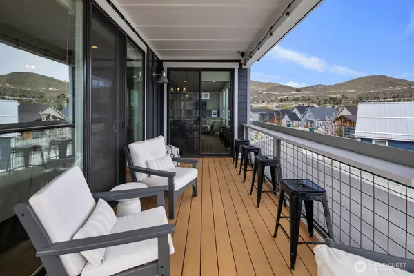 a view of a balcony with table and chairs