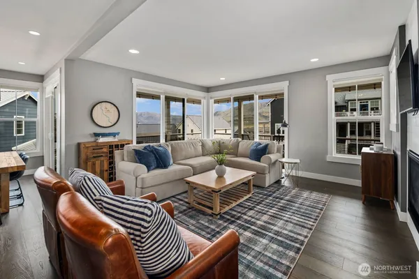 a living room with furniture and wooden floor