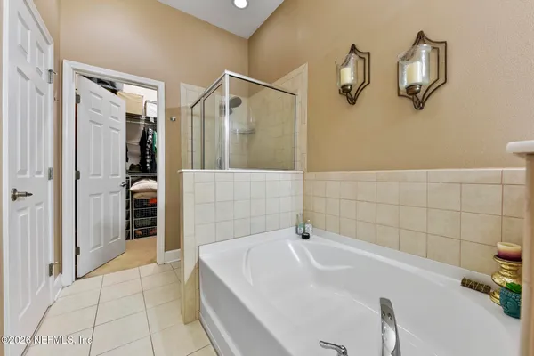a spacious bathroom with a double vanity sink and a mirror