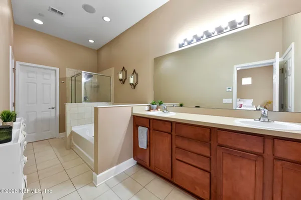 a spacious bedroom with a bed and a large window