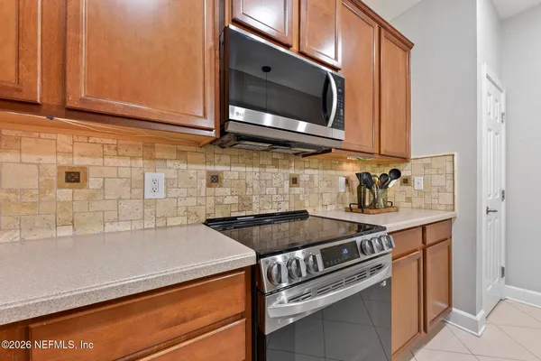 a kitchen with stainless steel appliances a stove a microwave and sink