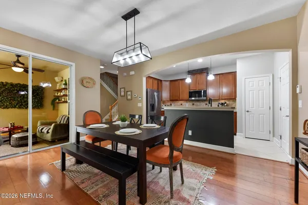 a view of a dining room with furniture wooden floor and chandelier