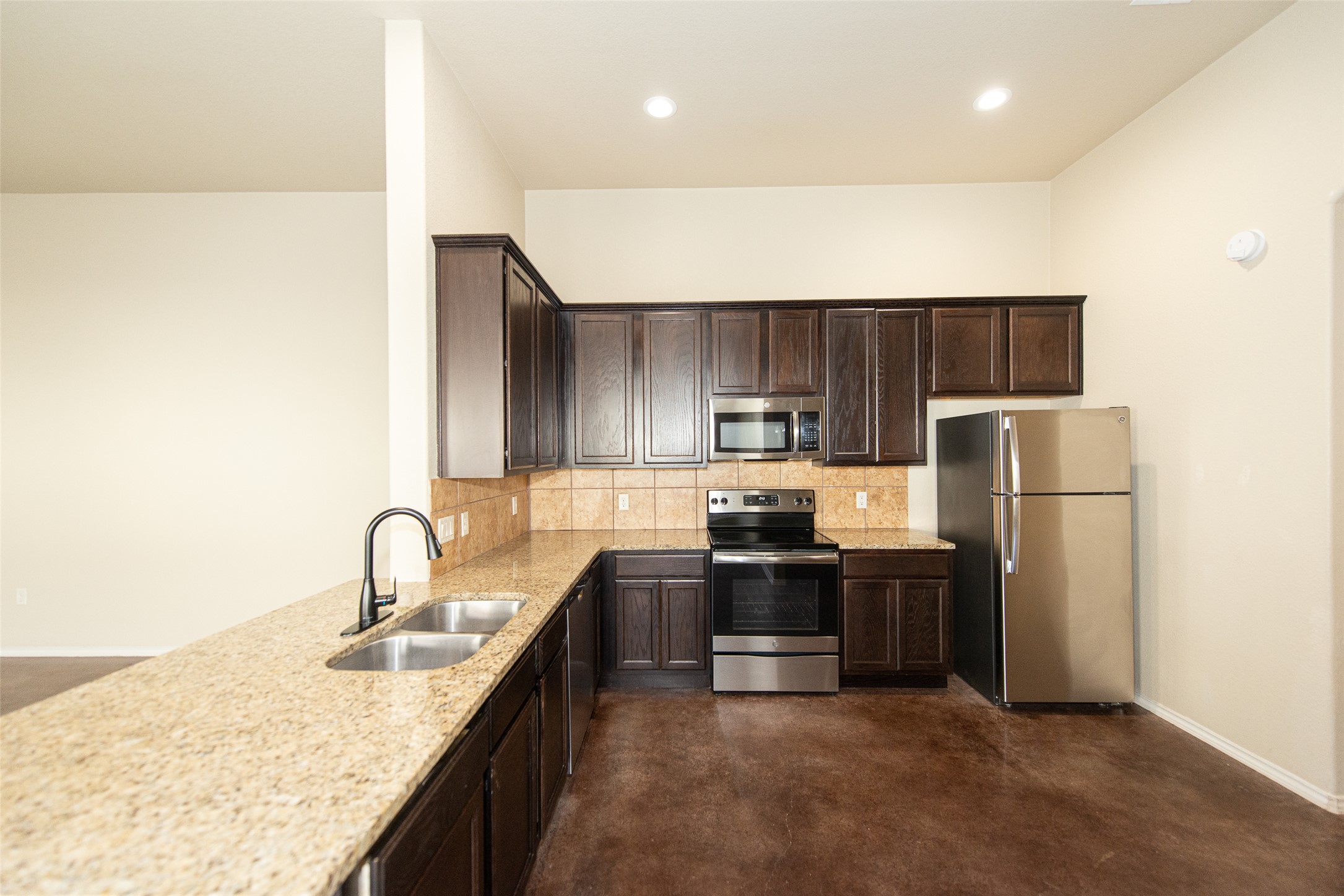245 Joanne Loop, Unit B Buda, TX 78610 - Photo 6 of 33 Granite counters, stainless appliances, refrigerator, range and dishwasher